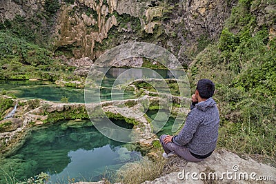 Young male watching the beautiful Waterfall hidden in the & x28;EL SALTO-EL MECO& x29; san luis potosi Mexico Editorial Stock Photo