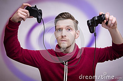 Young man addicted to video games Stock Photo