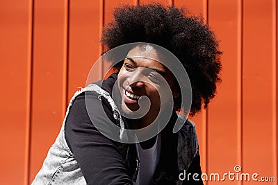 Young man with afro smiling and looking away Stock Photo