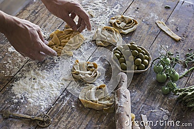 The young man in an apron preparing homemade pasta Stock Photo