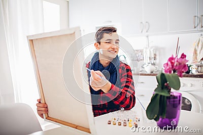 Young man artist painting at home creative painting Stock Photo