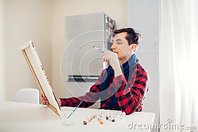 Young man artist painting at home creative painting Stock Photo