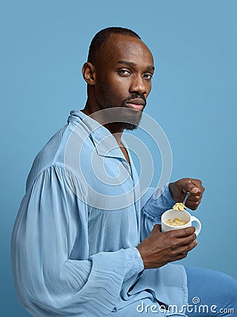 Young man as a medieval grandee on blue background Stock Photo