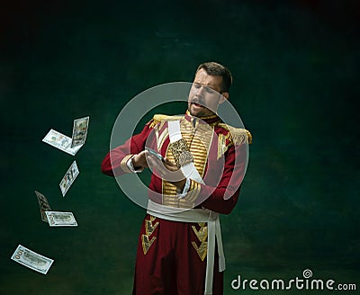 Young man as Nicholas II on dark green background. Retro style, comparison of eras concept. Stock Photo