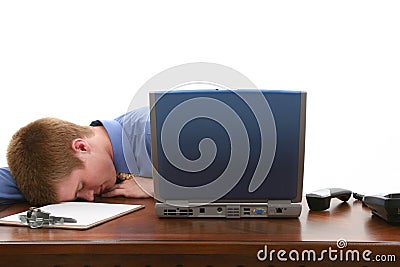 Young Man Asleep at Desk Stock Photo