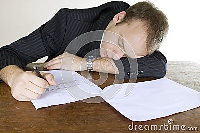 Young man asleep on office desk Stock Photo