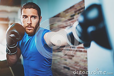 Young man athlete boxing workout in fitness gym on blurred background.Athletic man training hard.Kick boxing concept Stock Photo