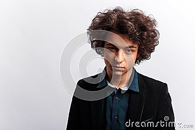 Portrait of dubious young man with awesome hairdo, looking pensive, isolated on white background. Vertical view. Stock Photo