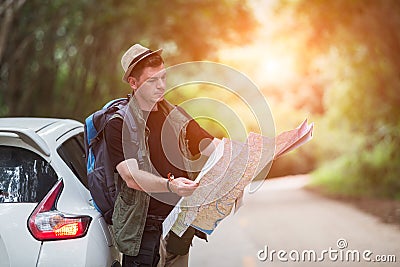 Young man backpacker travelling and photographer with car Stock Photo