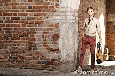 Young man with bag on street, old town Gdansk Stock Photo