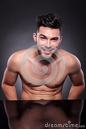 Young man with bare chest smiles at you Stock Photo