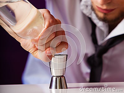 Young man bartender preparing alcohol drink Stock Photo