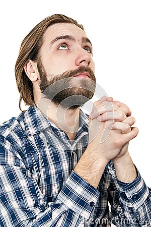 The young man with a beard prays to god Stock Photo