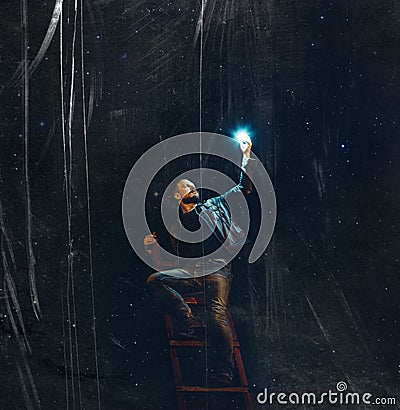 A young man with a beard on the stairs holds a star against the background of the night sky with scratches. creative concept Stock Photo