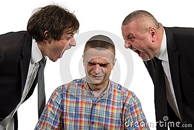 Young man being yelled at by two senior male manager on white Stock Photo