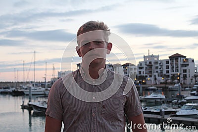 Young man on the berth with yachts in Agadir port, Morocco. Stock Photo
