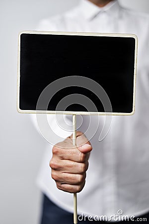 Young man with a blank black signboard Stock Photo