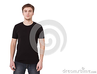 Young man in blank black tshirt isolated on white background. Copy space. Place for advertisement. Front view of T-shirt. Stock Photo