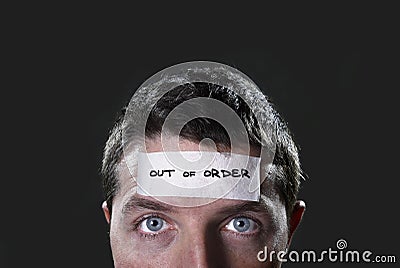 Young man with blue eyes and tape text out of order on forehead in dry empty mind Stock Photo