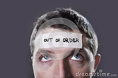 Young man with blue eyes and tape text out of order on forehead in dry empty mind Stock Photo