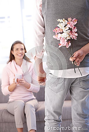 Young man bringing flowers to woman Stock Photo