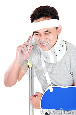 Young man with broken arm talking on the phone Stock Photo