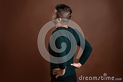 Man with brown hair has back pain Stock Photo