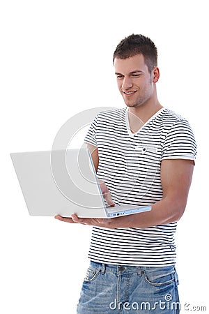 Young man browsing internet smiling Stock Photo