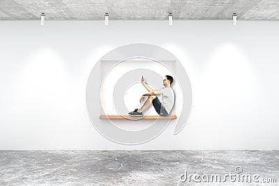 Young man on built-in-wall seating Stock Photo