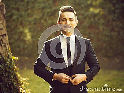 Young man buttons suit coat Stock Photo