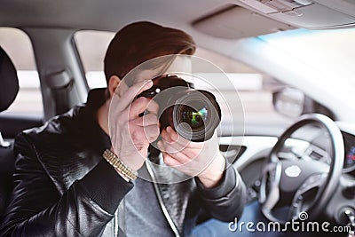 Young man with a camera in the car Stock Photo