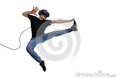 Young man in casual clothes using VR headset for playing game and imagin himself a fighter Stock Photo
