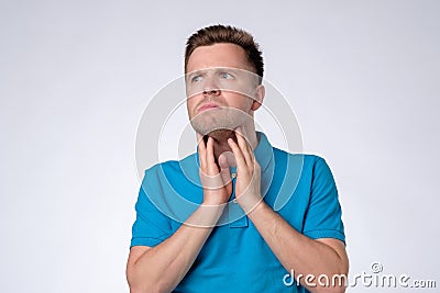 Young man checking his lymph node on throat Stock Photo