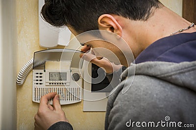 Young man checking the speaker phone and alarm Stock Photo