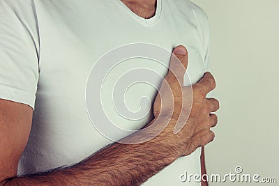 Young man chest pain or heart attack on white backgrou Stock Photo