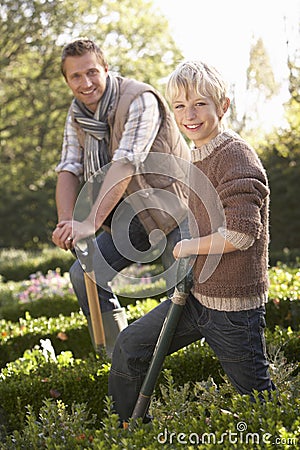 Young man with child working in garden Stock Photo