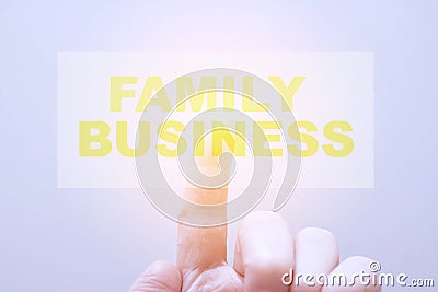 Young man clicks on hologram with text - family business Stock Photo