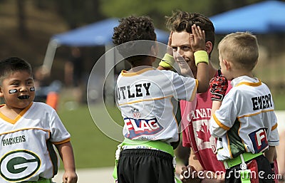 A Young Man Coaching a Flag Football Team Editorial Stock Photo