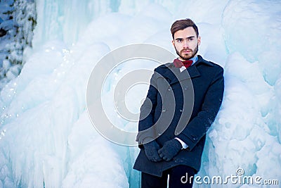 The young man in a coat in the winter Stock Photo