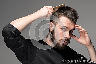 Young man comb his hair Stock Photo