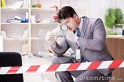 The young man during crime investigation in office Stock Photo