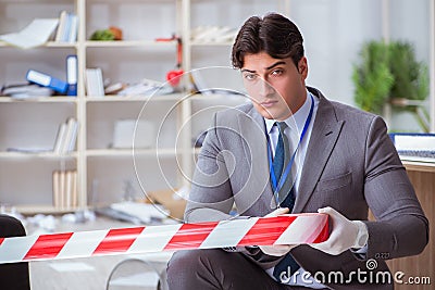 The young man during crime investigation in office Stock Photo