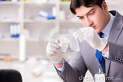 The young man during crime investigation in office Stock Photo