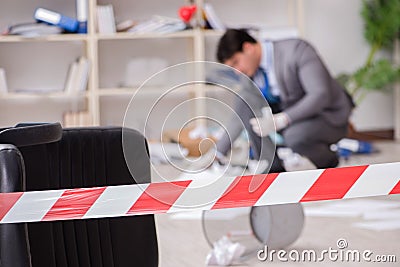 The young man during crime investigation in office Stock Photo