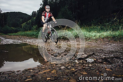 The young man cycling on mountain bike ride Cross-country Stock Photo