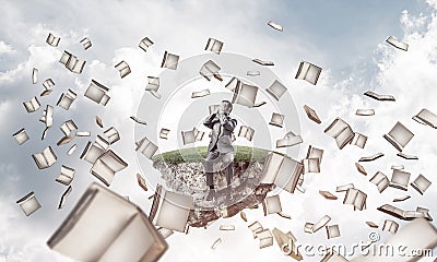 Young man do not want to see anything and books fly around Stock Photo