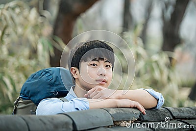 Young man doing a backpacking trip in a Korean traditional house. Stock Photo