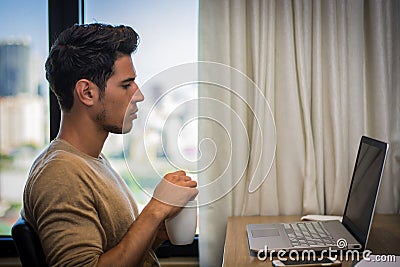 Young Man with Doing Homework at Computer Desk Stock Photo