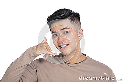 Young man doing phone gesture like says call me back Stock Photo