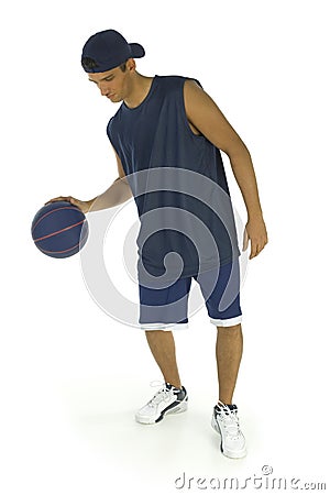 Young man dribbling basketball Stock Photo